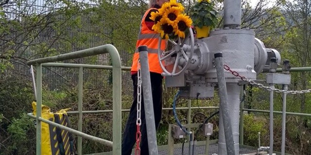 A member of the "Last Generation" activates the emergency shut-off at pipeline in Germany. 