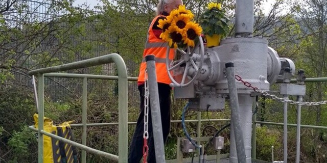 A member of the "Last Generation" activates the emergency shut-off at pipeline in Germany. 