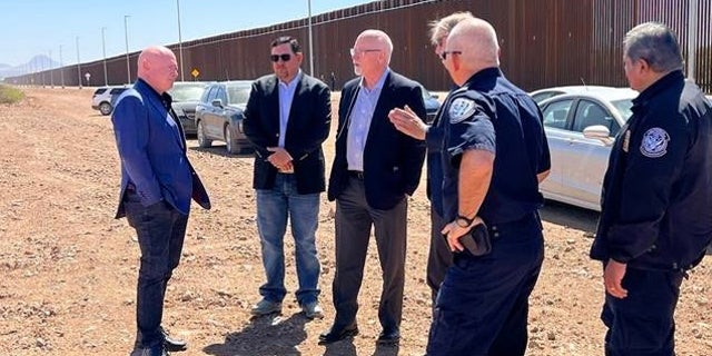 Senator Mark Kelly of Arizona (left) meets with U.S. Customs and Border Protection officials at the Douglas Port of Entry along the U.S.-Mexico border, April 13, 2022