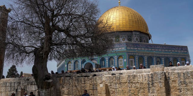 Muslim worshippers gather for Friday prayers, next to the Dome of the Rock Mosque in the Al Aqsa Mosque compound in Jerusalem's old city, Friday, April 1, 2022.