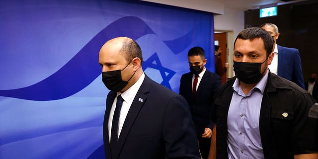 Israeli Prime Minister Naftali Bennett, left, attends a cabinet meeting at the Prime Minister's office in Jerusalem Sunday, April 10, 2022.