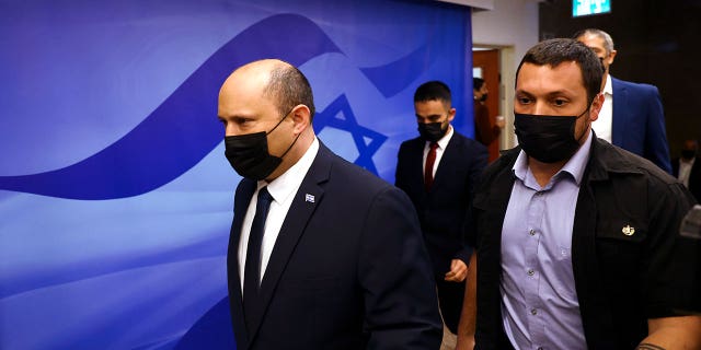 Israeli Prime Minister Naftali Bennett, left, attends a cabinet meeting at the Prime Minister's office in Jerusalem Sunday, April 10, 2022.