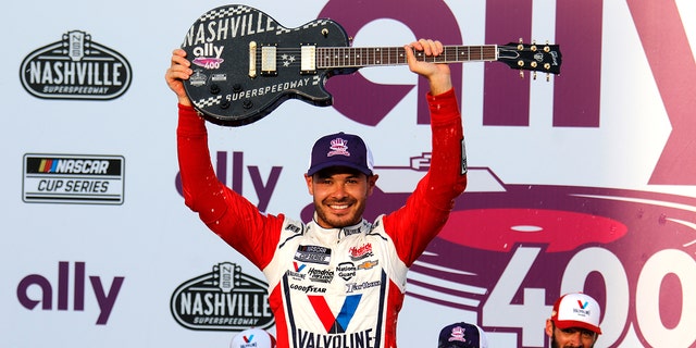  Kyle Larson received a Gibson Guitar Trophy for winning the 2021 Ally 400 at Nashville Superspeedway.