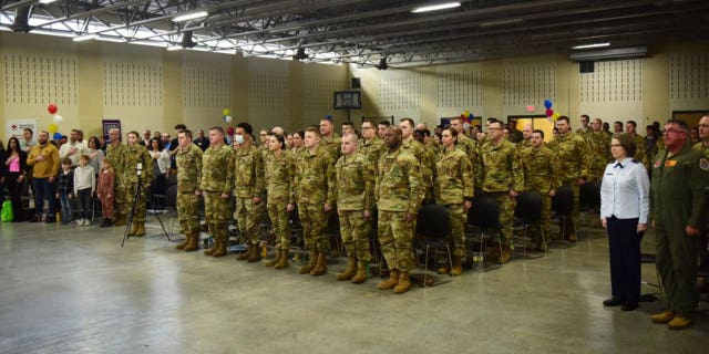 Airmen assigned to the Ohio Air National Guard’s 178th Wing stand at attention, along with family and friends during a Call to Duty ceremony March 6, 2022 in Springfield, Ohio. The Airmen are scheduled to deploy to support U.S. Central Command operations. (U.S. Air National Guard photo by Airman Colin Simpson)