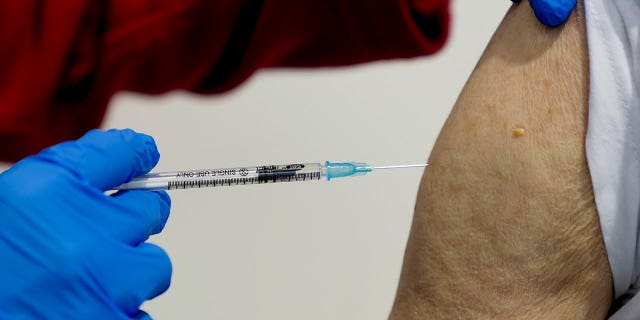 An 87-year-old man gets his booster shot at the vaccination center in Frankfurt, Germany, on Nov. 11, 2021.