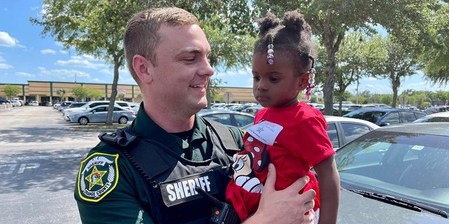 Orange County Sheriff’s Deputy William Puzynski and 2-year-old Sophia reunited on Tuesday after the deputy helped rescue the child from an apartment fire in Orlando over the weekend.