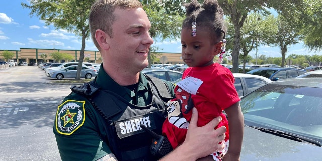 Orange County Sheriff’s Deputy William Puzynski and 2-year-old Sophia reunited on Tuesday after the deputy helped rescue the child from an apartment fire in Orlando over the weekend.