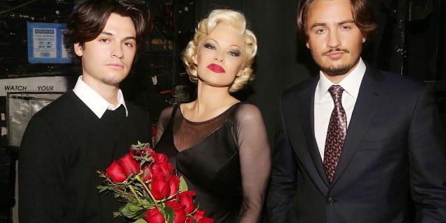 From left, Dylan Jagger Lee, Pamela Anderson and Brandon Thomas Lee pose backstage during the opening night of her Broadway debut as Roxie Hart in the musical "Chicago" on Broadway.