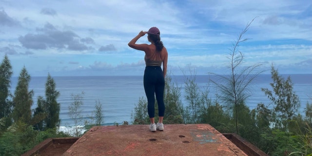 A visitor is shown standing on top of the remains of a WWII pillbox bunker during a hike in Oahu, Hawaii, this past March.