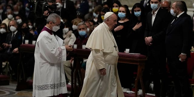 Pope Francis walks past Melitopol Mayor Ivan Fedorov, second from right, and Ukrainian lawmakers during an Easter vigil ceremony in St. Peter's Basilica at the Vatican Saturday, April 16, 2022. 