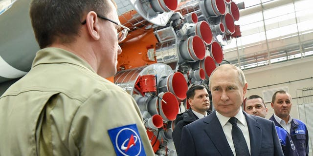 Russian President Vladimir Putin speaks with Roscosmos space agency employees at a rocket assembly factory during his visit to the Vostochny cosmodrome.