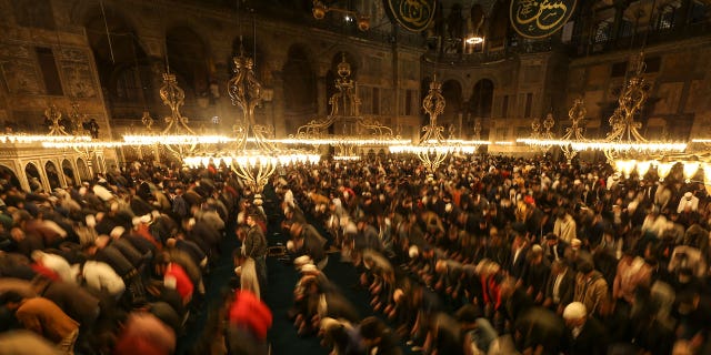 Muslim worshippers perform a night prayer called "tarawih" during the eve of the first day of the Muslim holy fasting month of Ramadan at Hagia Sophia mosque in Istanbul, Turkey, Friday, April 1, 2022. 