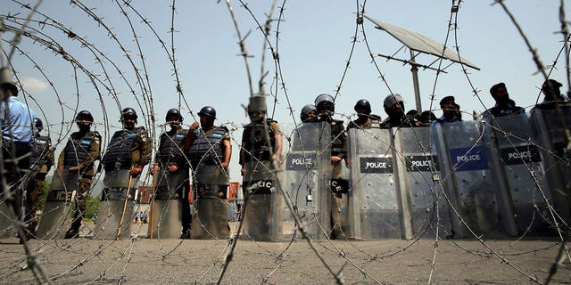 Security personnel stand guard during a protest in Islamabad, Pakistan, Sunday, April 3, 2022.