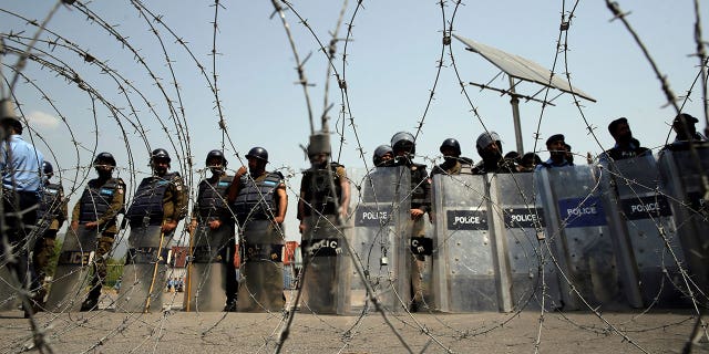 Security guards stand guard during a political protest in Islamabad, Pakistan, on Sunday, April 3, 2022.