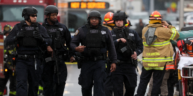 Law enforcement officers work near the scene of a shooting at a subway station in the Brooklyn borough of New York City, New York, U.S., April 12, 2022