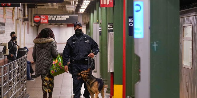 Police officers patrol a subway station in New York, Tuesday, April 12, 2022.