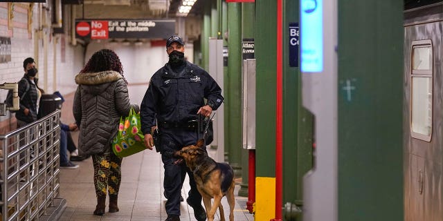 Police officers patrol a subway station in New York, Tuesday, April 12, 2022. Multiple people were shot and injured Tuesday at a subway station in New York City during a morning rush hour attack that left wounded commuters bleeding on a train platform. (AP Photo/Seth Wenig)