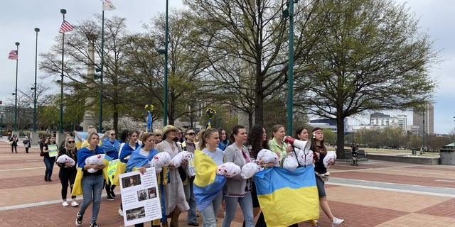 Mothers go on a separate march during a rally in an effort to bring attention to the children killed in the war in Ukraine.