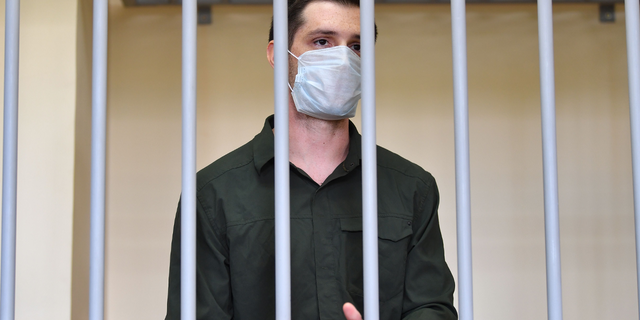 Trevor Reed, charged with attacking police, stands inside a defendants' cage during his verdict hearing at Moscow's Golovinsky district court on July 30, 2020.