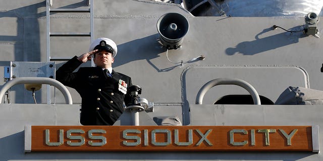 A sailor salutes from the USS Sioux City during the ship's commissioning ceremony, Nov. 17, 2018, in Annapolis, Maryland.