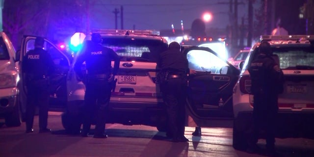 Philadelphia police officers at the scene where a transit officer and two women were shot Wednesday by a gunman who barricaded himself in an apartment building before apparently