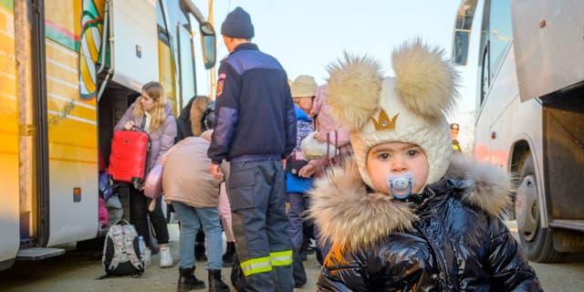 Nineteen-month-old MIlana is one of many Ukrainian refugees who have stopped at the Husi
camp in Romania for
hot tea and snacks, and to take a break from their long bus ride.
