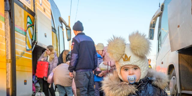 Nineteen-month-old MIlana is one of many Ukrainian refugees who have stopped at the Husi
camp in Romania for
hot tea and snacks, and to take a break from their long bus ride.