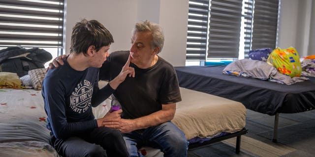 Bogdon, 16, shares a moment with his father Vladimir.
They are currently at a
shelter in Romania after fleeing Ukraine. (World Vision)