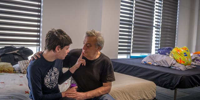 Bogdon, 16, shares a moment with his father Vladimir.
They are currently at a
shelter in Romania after fleeing Ukraine. (World Vision)