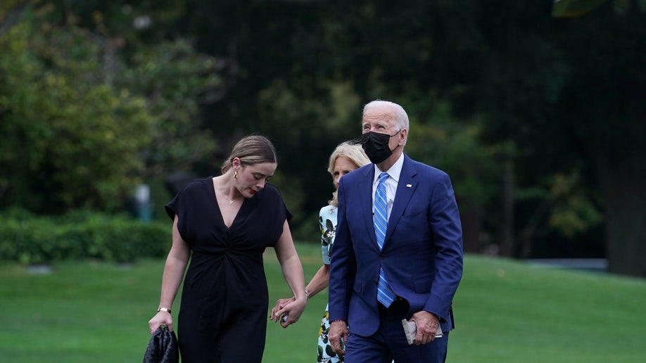 U.S. President Joe Biden, U.S. first lady Jill Biden and granddaughter Naomi Biden walk from the Marine One helicopter on the South Lawn to the White House in Washington, U.S., October 11, 2021. 