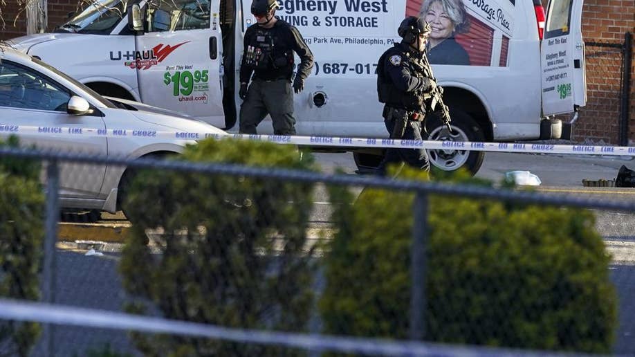 Bomb squad personnel search a moving truck during an ongoing investigation in the Brooklyn borough of New York, Tuesday, April 12, 2022.