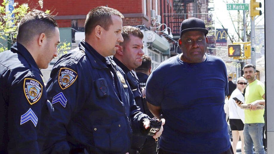 New York City Police Department officers arrest subway shooting suspect Frank R. James, 62, in the East Village section, of New York, Wednesday, April 13, 2022. The man accused of shooting multiple people on a Brooklyn subway train was arrested Wednesday and charged with a federal terrorism offense after a daylong manhunt and a tipster's call brought police to him on a Manhattan street.