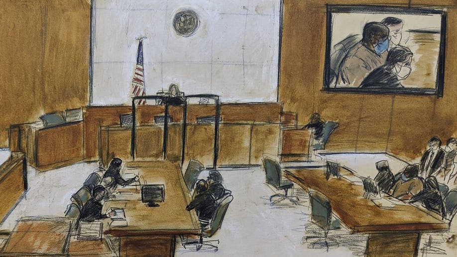In this sketch of the courtroom, Frank James, seated in the center of the right table and left of the screen, top right, appears during the brief proceeding in federal court in the Brooklyn borough of New York, Thursday, April 14, 2022. James, accused of opening fire on a crowded subway train in Brooklyn, was sentenced to detention without bail as prosecutors told a judge on Thursday he terrified the whole new York City.
