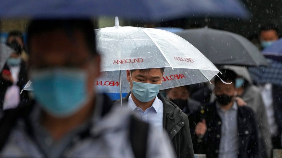 Beijing commuters walk out of a subway