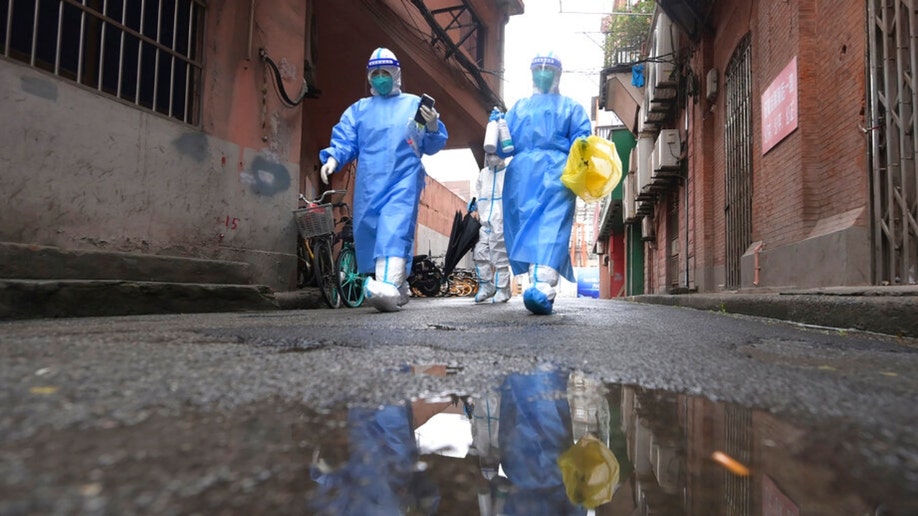 COVID-19 staff members head to conduct tests for residents released from makeshift hospitals in Shanghai