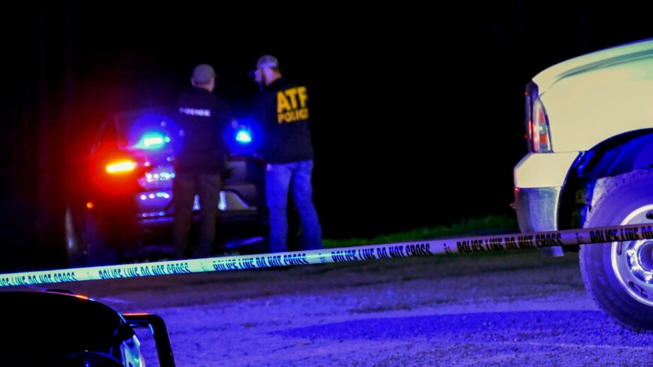 Law enforcement investigates the scene of a fatal robbery at a Georgia gun range