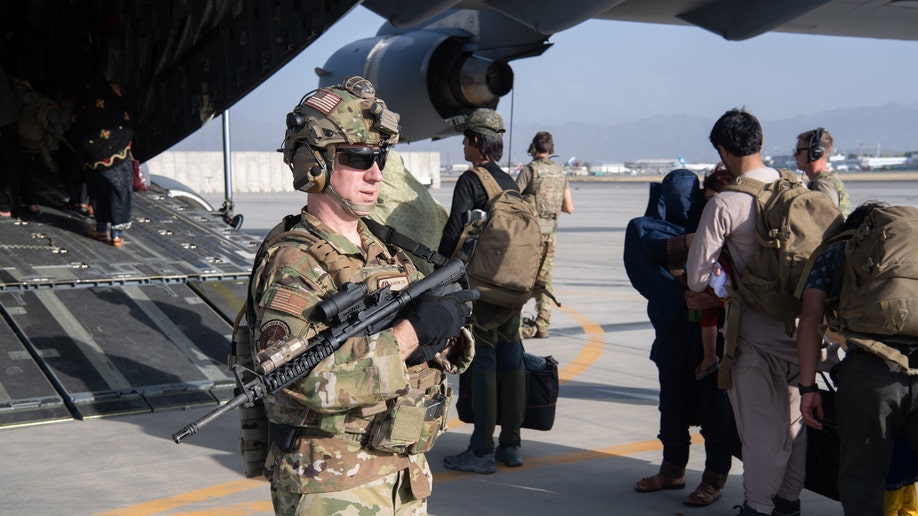 In this handout provided by U.S. Central Command Public Affairs, U.S. Air Force loadmasters and pilots assigned to the 816th Expeditionary Airlift Squadron, load passengers aboard a U.S. Air Force C-17 Globemaster III in support of the Afghanistan evacuation at Hamid Karzai International Airport