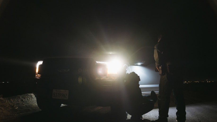 U.S. Border Patrol agents apprehend a migrant illegally crossing over the Mexico and U.S. border in Calexico, California, U.S., on Tuesday, Jan. 4, 2022. U.S. Customs and Border Protection made 173,620 arrests along the Southwest border, a 5% increase compared to October. 