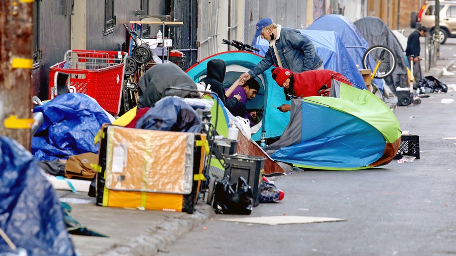 Homeless people consume illegal drugs in an encampment along Willow St. in the Tenderloin district of downtown on Thursday, Feb. 24, 2022 in San Francisco, CA. London Breed, mayor of San Francisco, is the 45th mayor of the City and County of San Francisco. She was supervisor for District 5 and was president of the Board of Supervisors from 2015 to 2018.