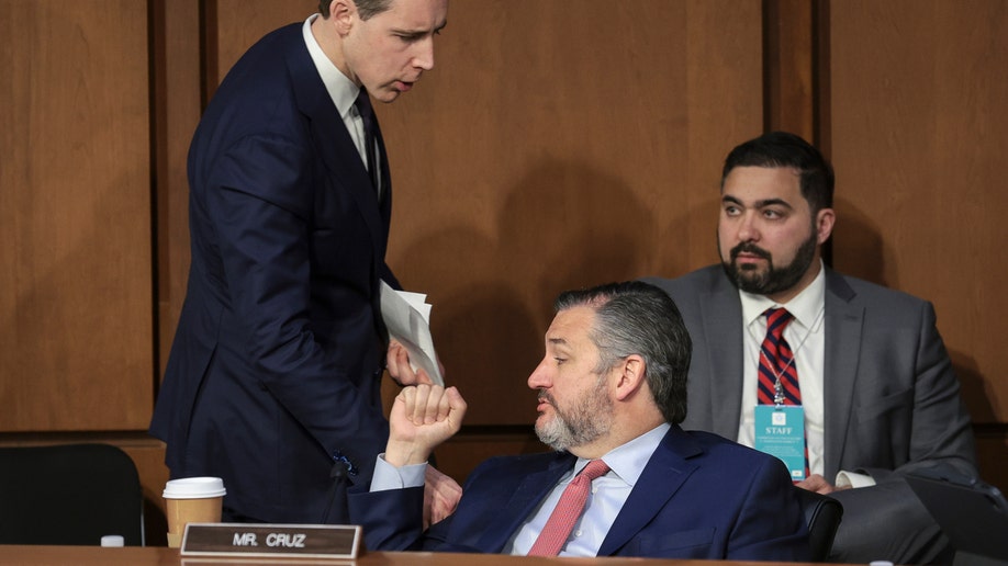Sen. Josh Hawley (R-MO) talks with Sen. Ted Cruz (R-TX) during a Senate Judiciary Committee business meeting to vote on Supreme Court nominee Judge Ketanji Brown Jackson on Capitol Hill, April 4, 2022 in Washington, DC. A confirmation vote from the full Senate will come later this week.