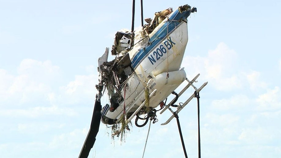 Helicopter debris being hoisted from a lake