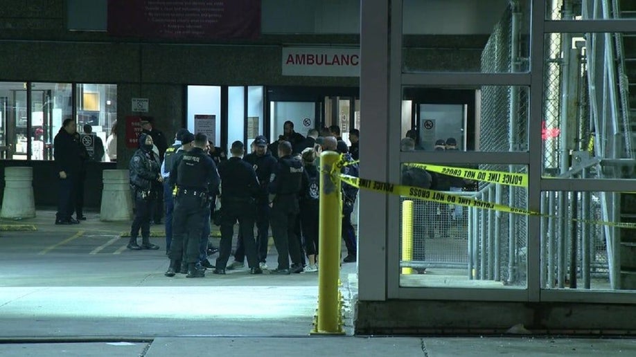 Officers stand outside a hospital where a SEPTA officer was recovering from a gunshot wound. 