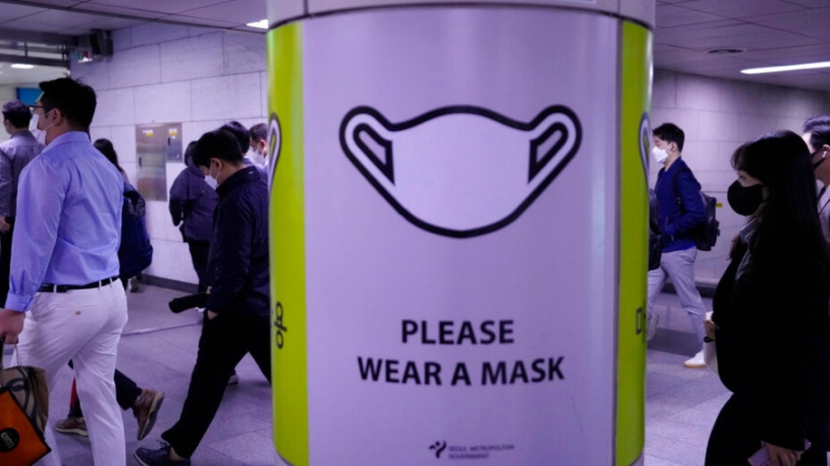 A poster instructs Seoul residents to wear a mask at a subway station