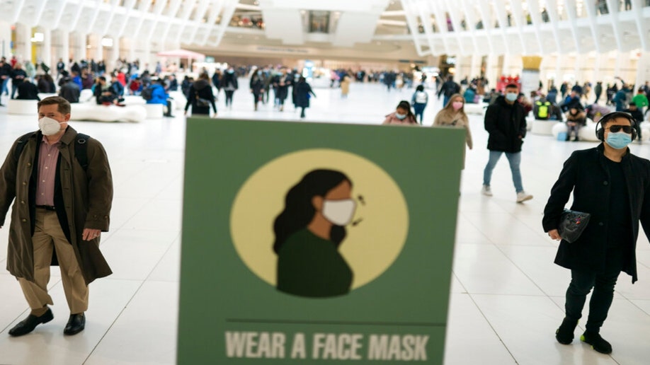 Mass transit riders wear masks in the financial district of lower Manhattan