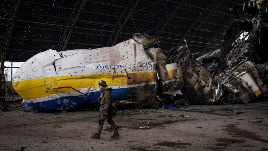 A Ukrainian serviceman walks past the Antonov An-225 aircraft.