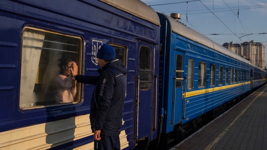 A Ukraine father says goodbye to his daughter at the train station in Odesa.