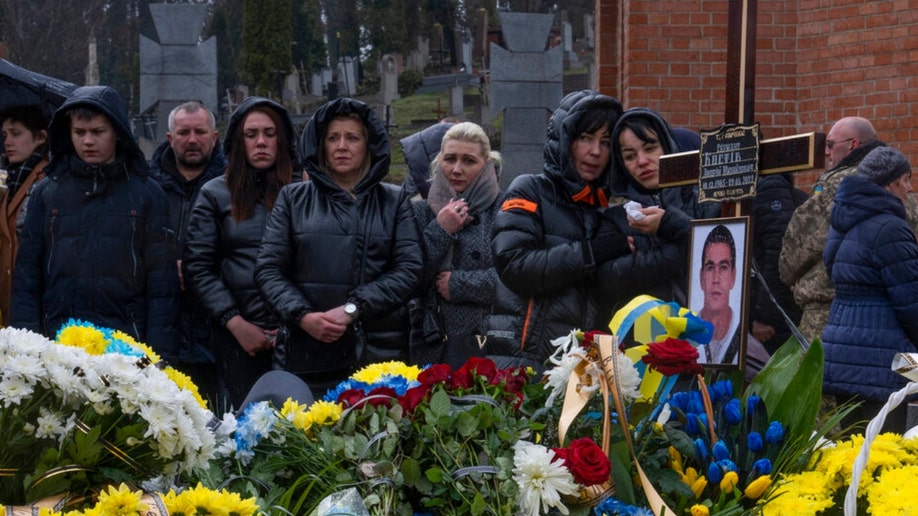 Family and friends at a funeral in Lviv, Ukraine.