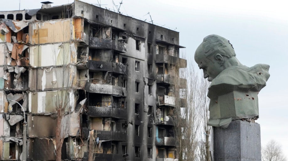 A Ukrainian monument and destroyed Borodyanka apartment building