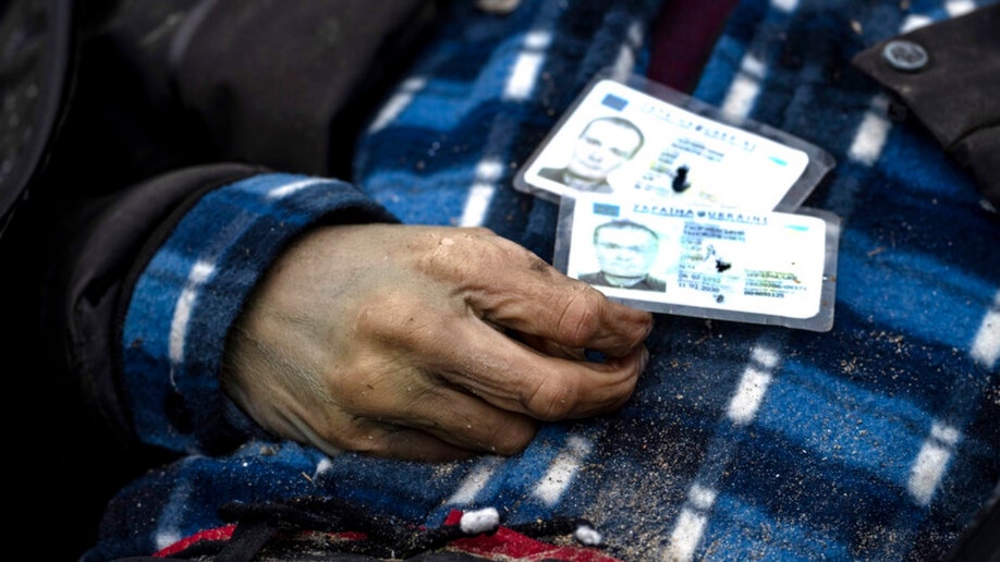 Identification cards on a man in Bucha