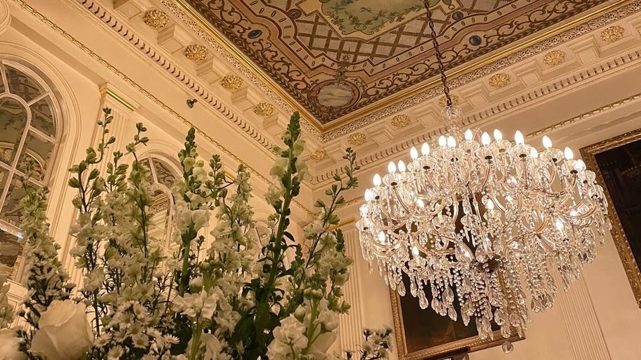 A chandelier hangs above a bouquet of flowers in the lobby of Hotel Monteleone in New Orleans